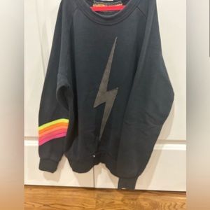 Charcoal gray Aviator Nation lightning bolt crewneck with neon stripes on sleeve